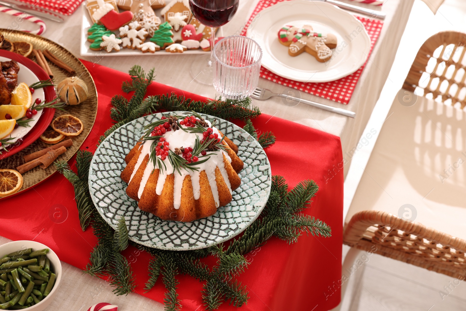 Photo of Festive dinner with delicious cake served on table indoors, above view. Christmas Eve celebration