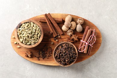 Photo of Different spices on light gray table, top view