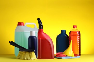 Photo of Different car cleaning products on yellow background