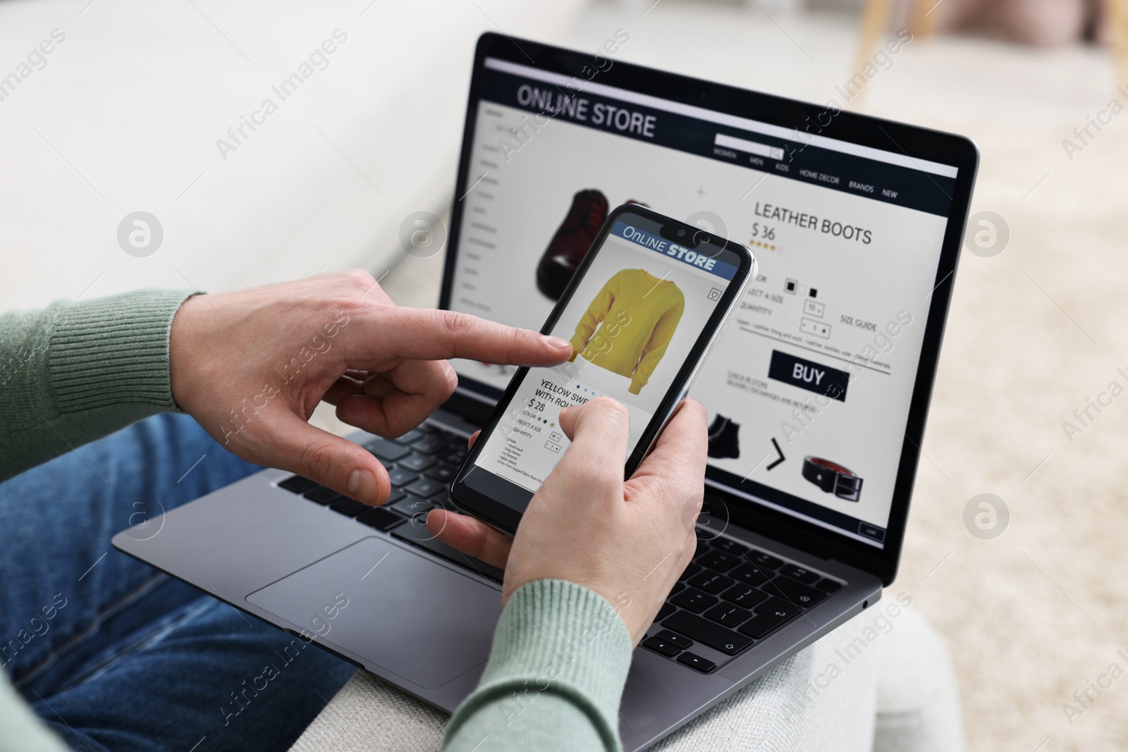 Photo of Man with smartphone and laptop shopping online indoors, closeup