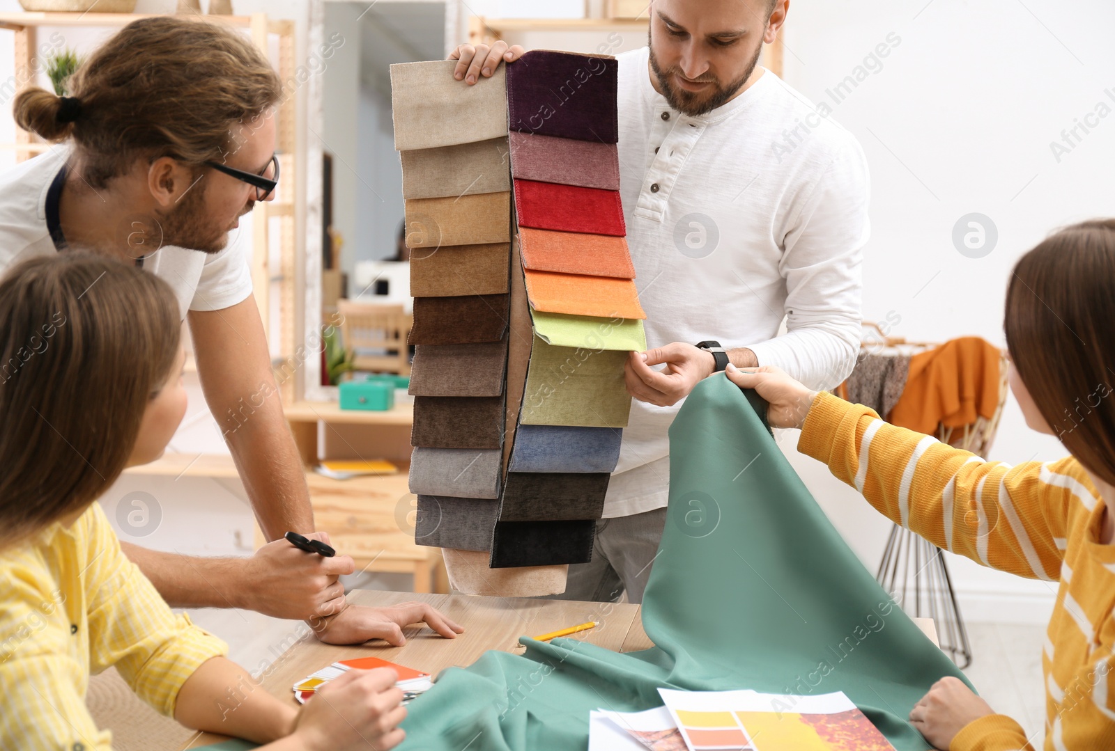 Photo of Fashion designers creating new clothes in studio