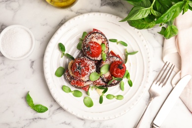 Photo of Baked eggplant with tomatoes, cheese and basil served on white marble table, flat lay