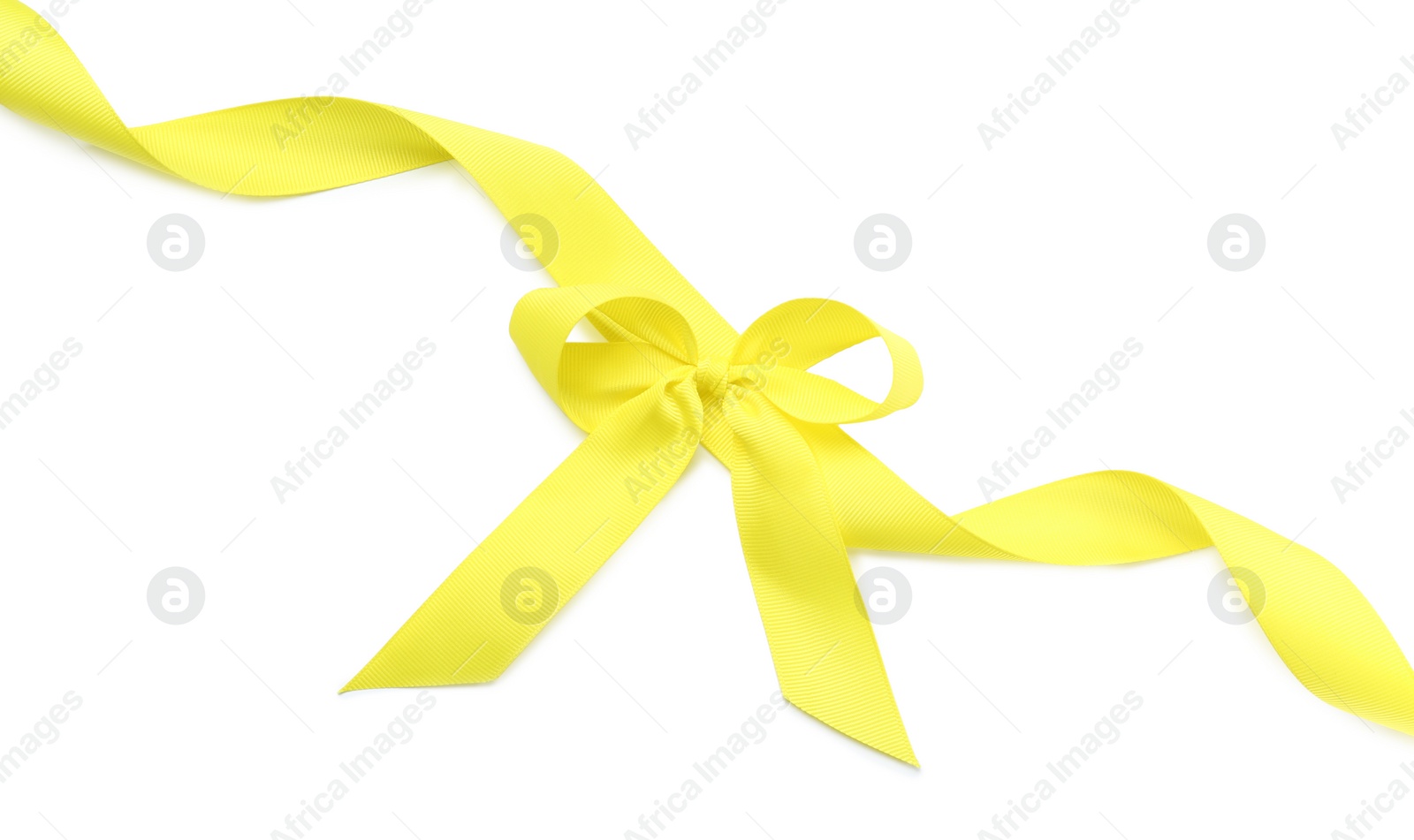 Photo of Yellow ribbon with bow on white background, top view