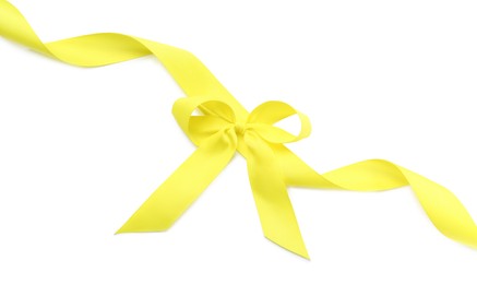 Yellow ribbon with bow on white background, top view