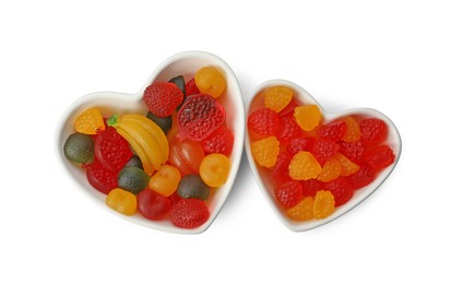 Delicious gummy fruit shaped candies on white background, top view