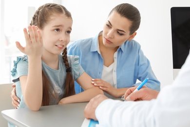 Young woman with her daughter having appointment at child psychologist office