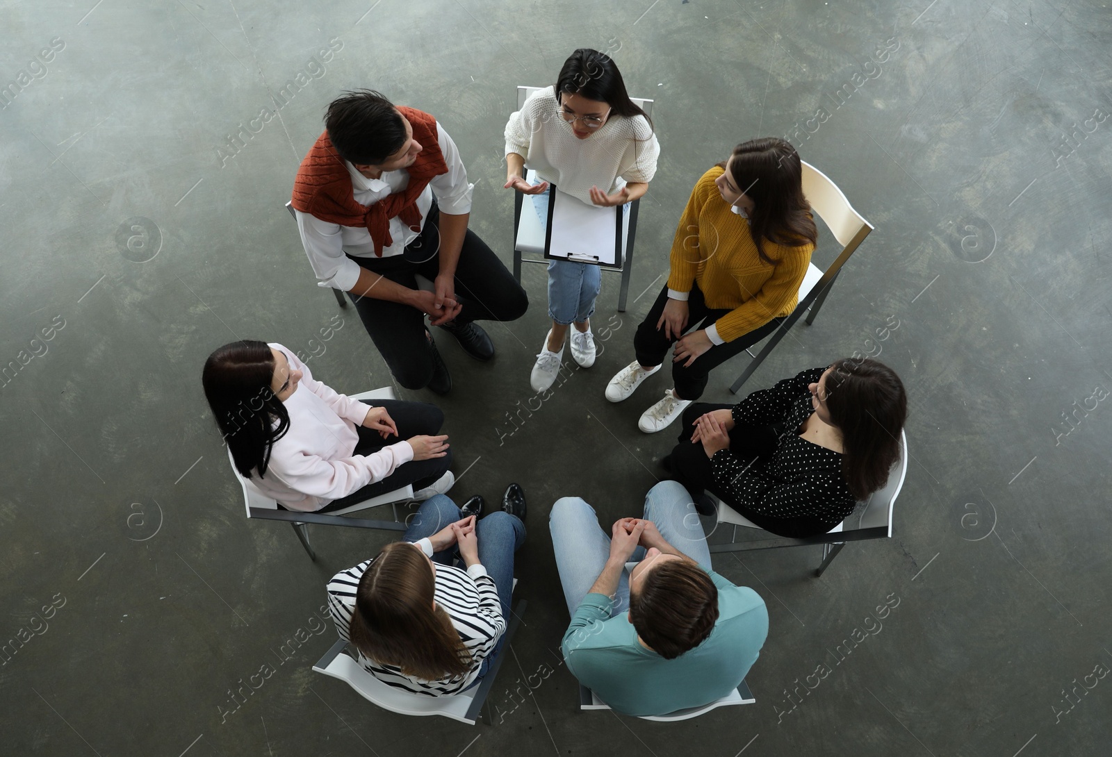 Photo of Psychotherapist working with patients in group therapy session, top view