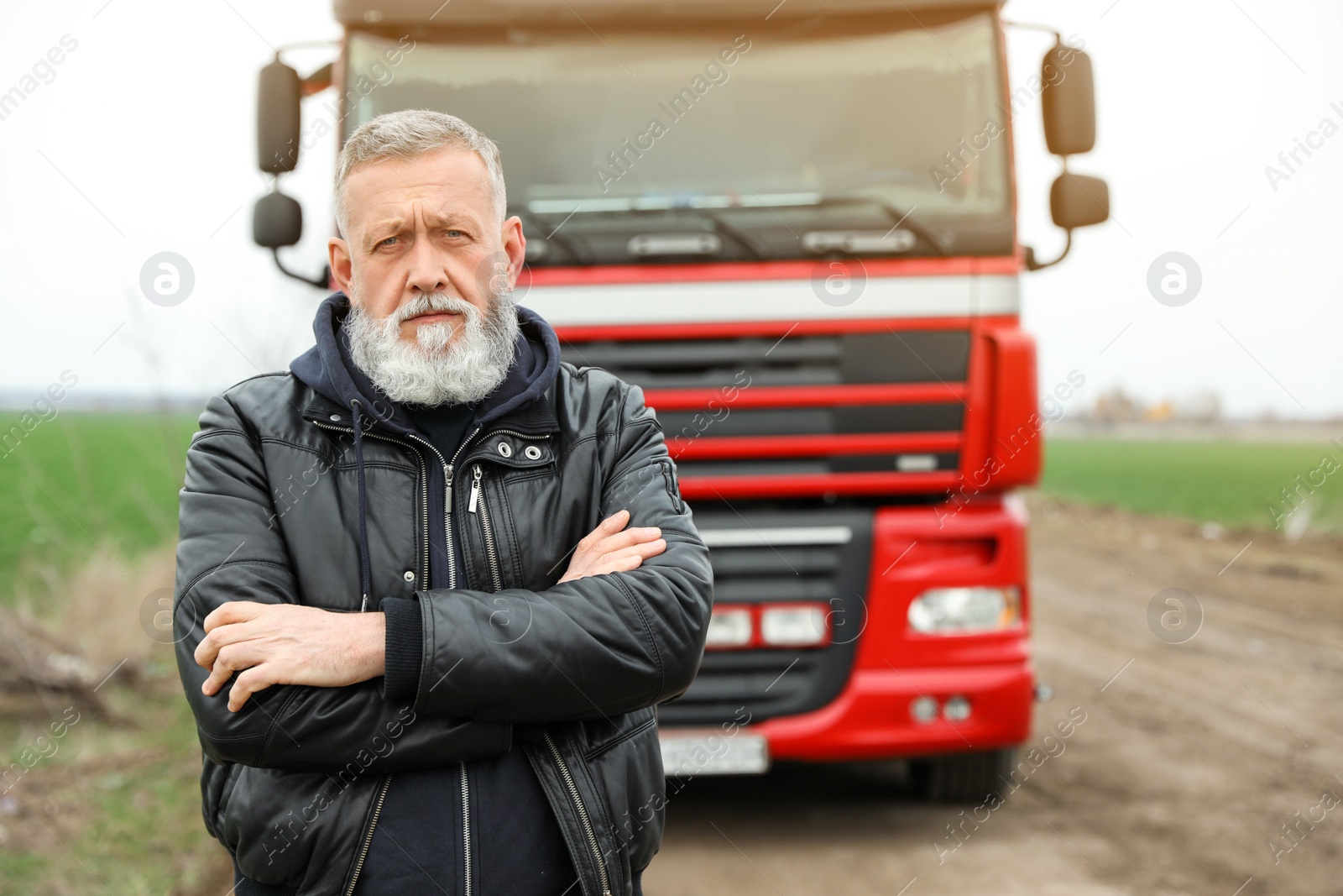 Photo of Portrait of mature driver at modern truck outdoors