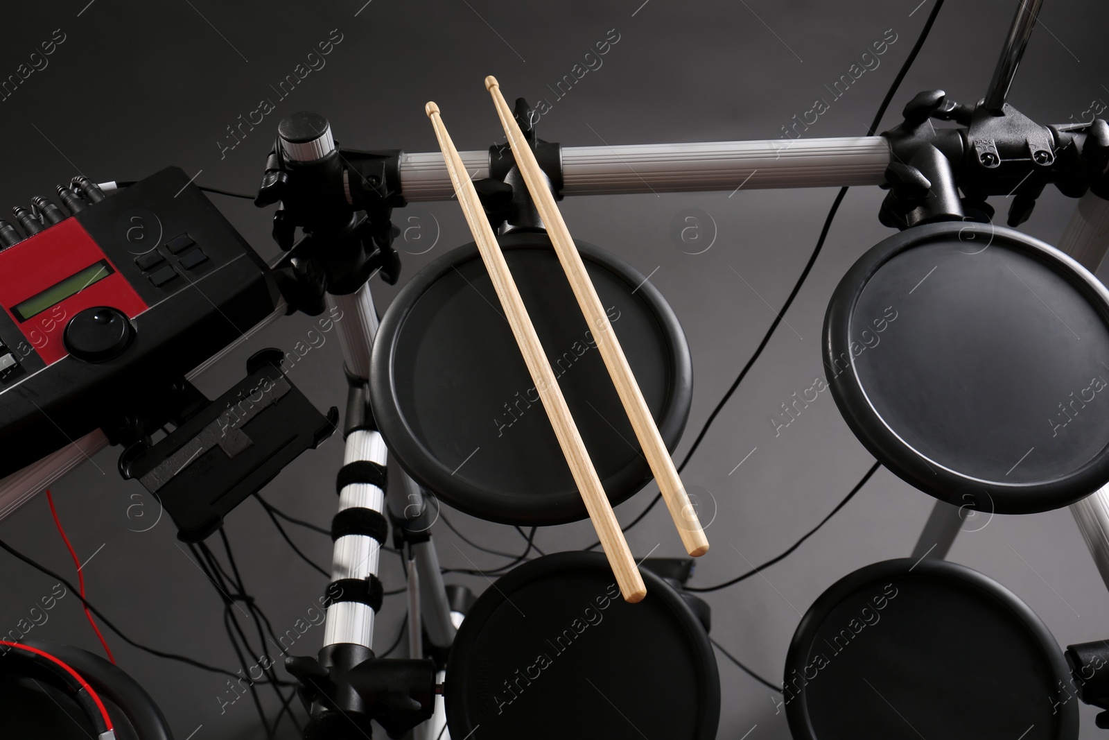 Photo of Modern electronic drum kit on grey background, above view. Musical instrument