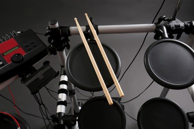 Photo of Modern electronic drum kit on grey background, above view. Musical instrument