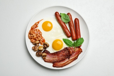 Traditional English breakfast with fried eggs on white table, top view