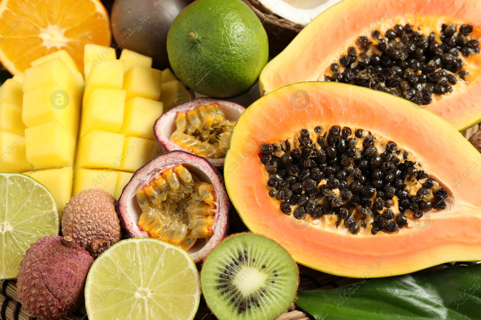 Photo of Fresh ripe papaya and other fruits as background, closeup