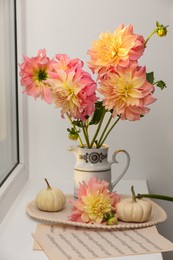 Photo of Beautiful composition with dahlia flowers on windowsill. Autumn atmosphere