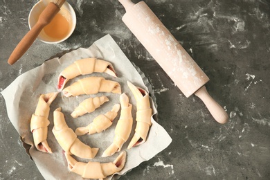 Baking dish with raw croissants on table, top view