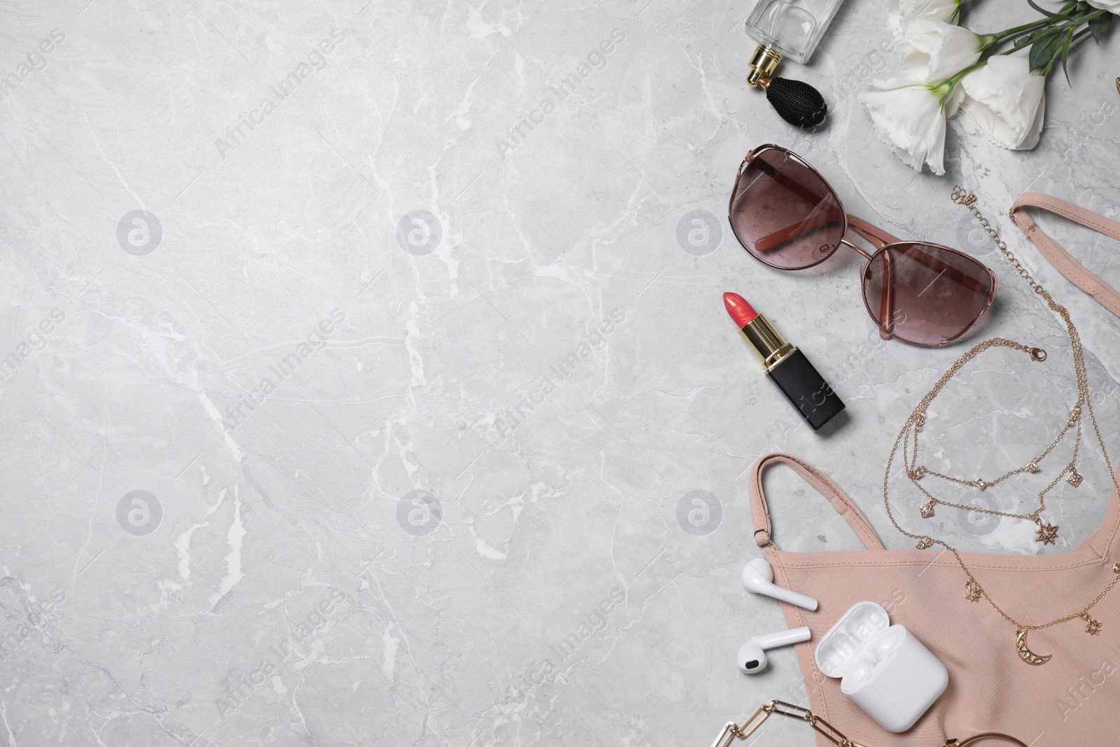 Photo of Flat lay composition with women's accessories on light grey marble background. Space for text