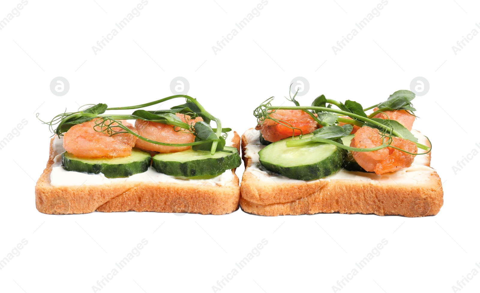 Photo of Tasty toasts with cream cheese, shrimps, cucumbers and microgreens on white background