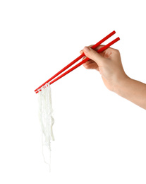 Woman holding chopsticks with tasty cooked rice noodles on white background, closeup