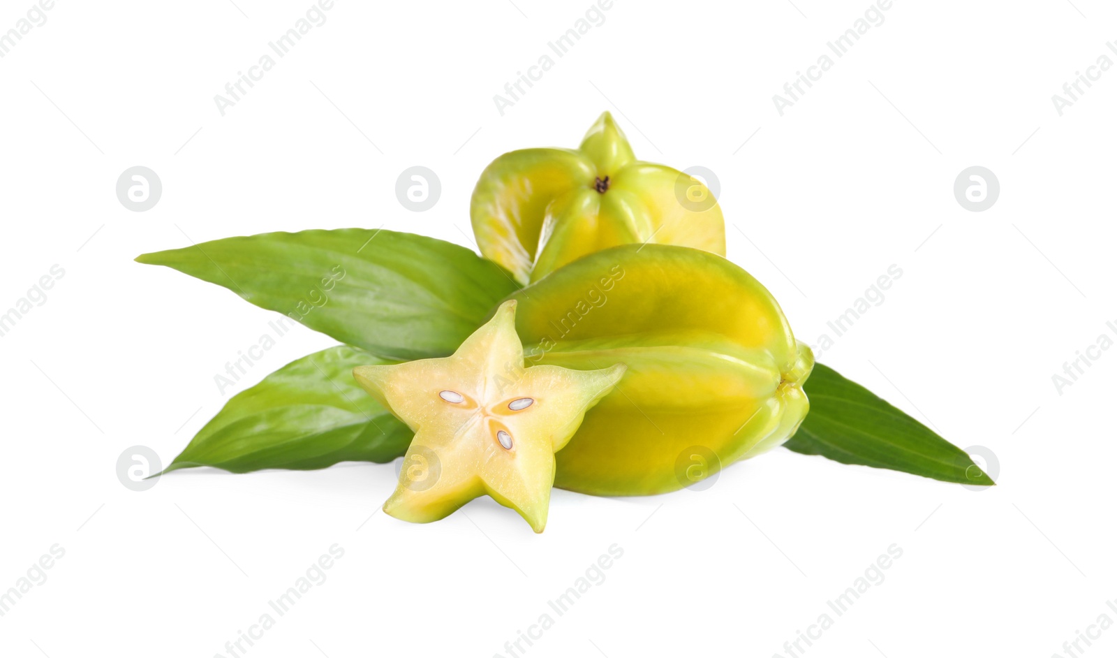Photo of Cut and whole carambolas with green leaves on white background