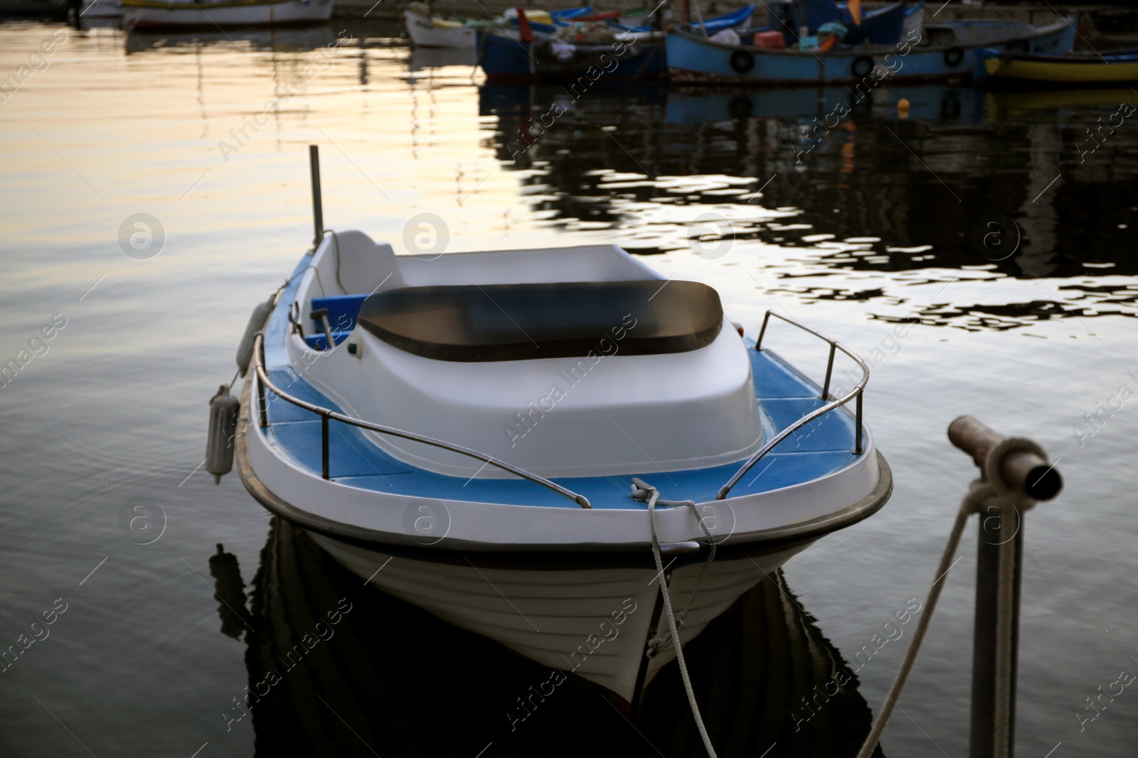 Photo of Beautiful view of river with moored boat at sunset