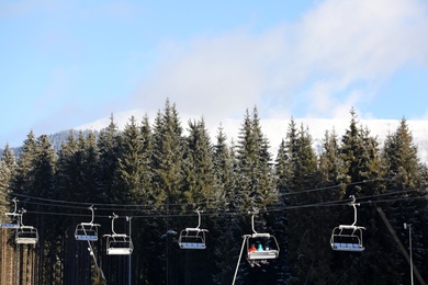 Photo of Beautiful landscape with mountain forest and chairlift. Winter vacation
