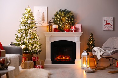 Photo of Stylish living room interior with beautiful fireplace, Christmas tree and other decorations