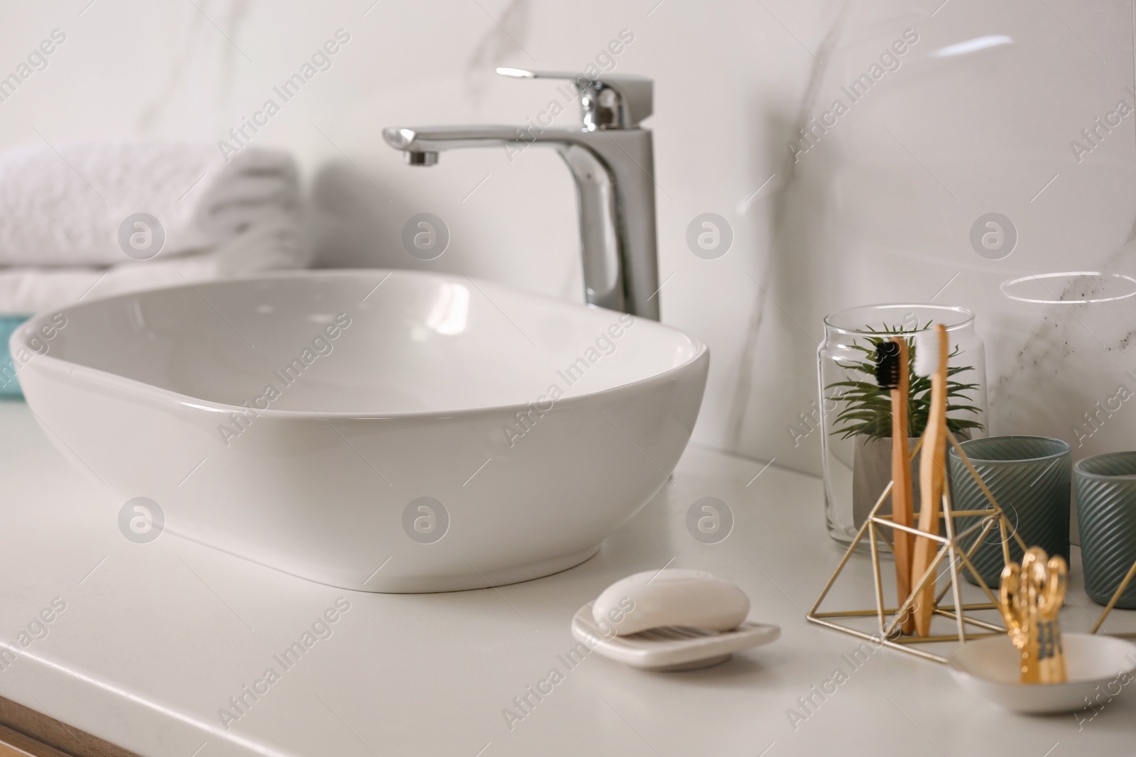 Photo of Stylish vessel sink on light countertop in modern bathroom