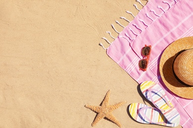Photo of Flat lay composition with stylish beach accessories on sand. Space for text