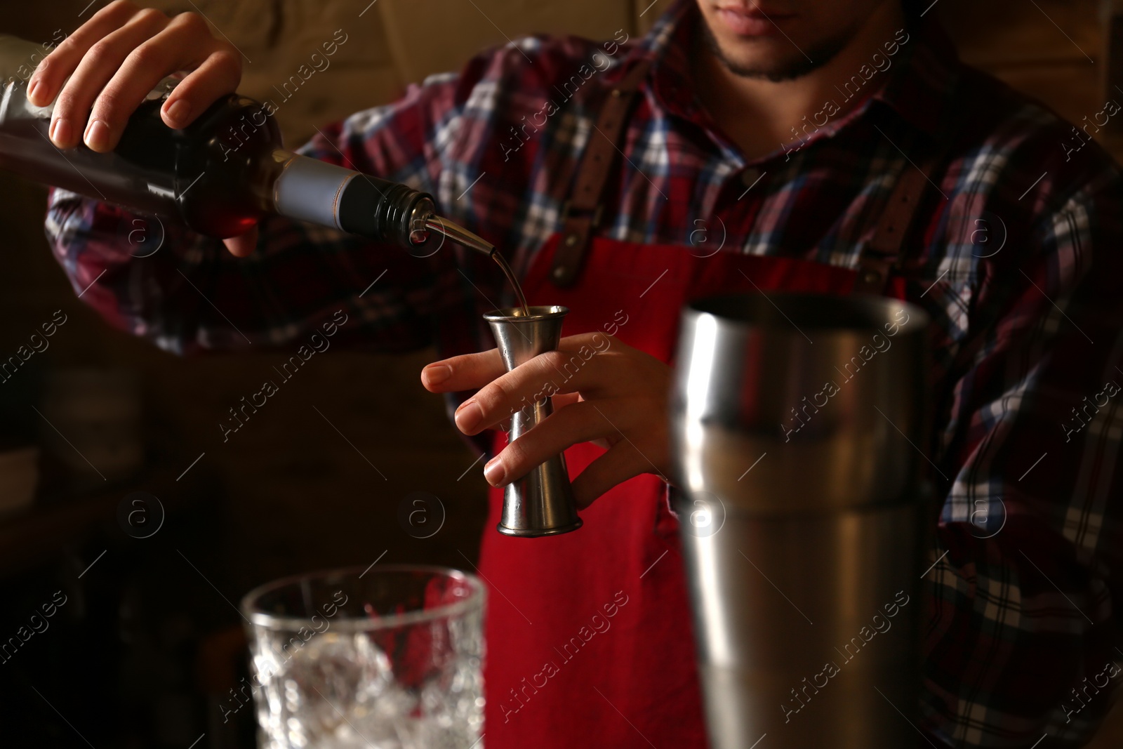 Photo of Bartender preparing fresh alcoholic cocktail in bar, closeup