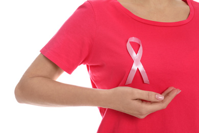 Photo of Woman with pink ribbon on white background, closeup. Breast cancer awareness