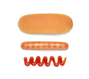 Photo of Bun, sausage and ketchup isolated on white, top view. Ingredients for hot dog