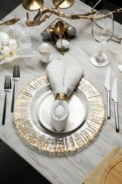 Photo of Easter table setting with bunny ears made of egg and napkin, above view