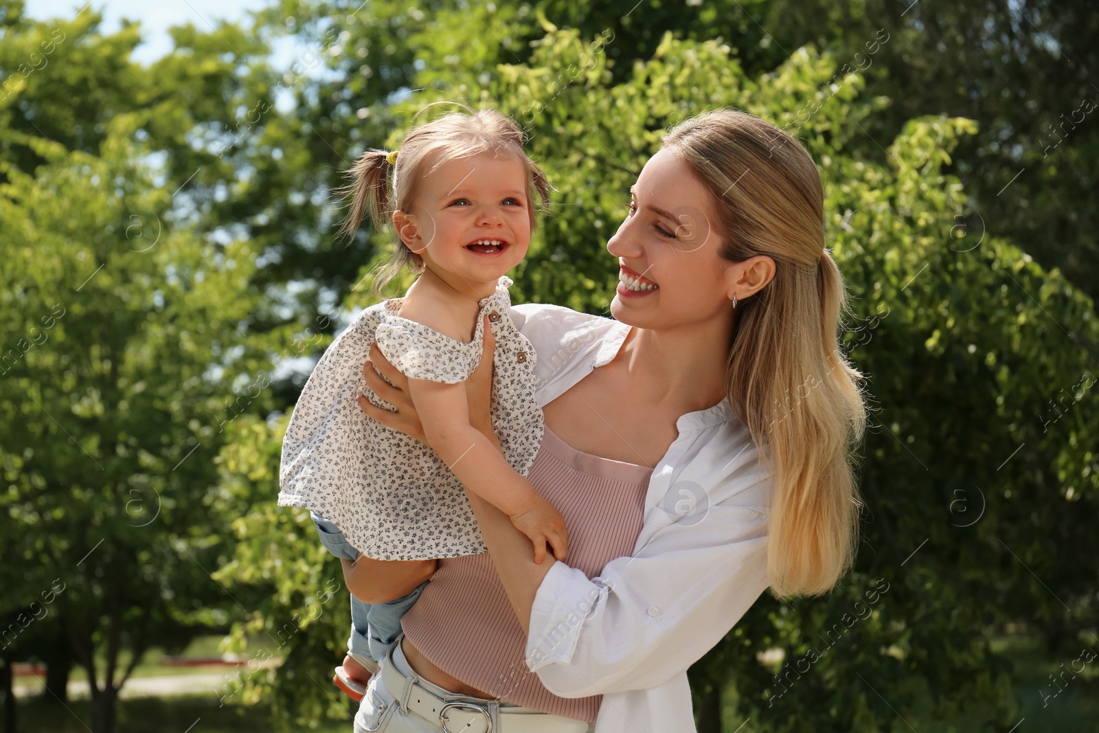 Photo of Happy mother with her daughter having fun in park