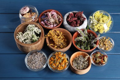 Photo of Many different herbs on blue wooden table