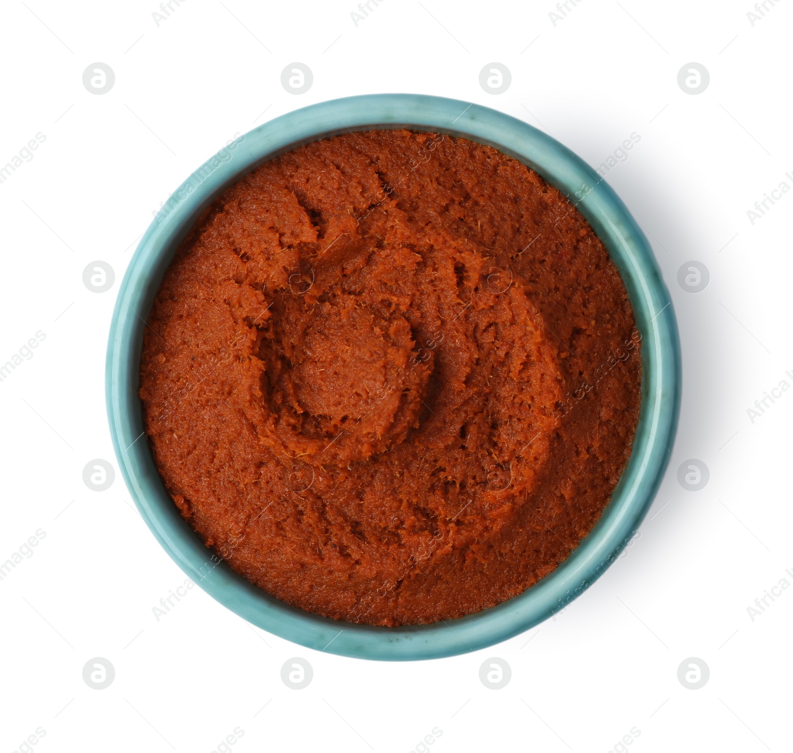 Photo of Tasty curry paste in bowl isolated on white, top view