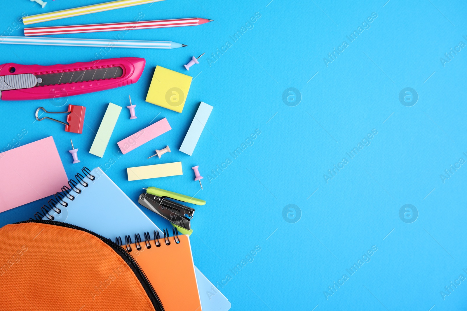 Photo of Different school stationery on light blue background, flat lay with space for text. Back to school