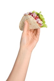 Photo of Woman holding delicious taco with meat and vegetables on white background, closeup