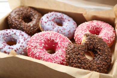 Sweet delicious glazed donuts in box, closeup