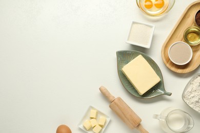 Photo of Flat lay composition with fresh butter among other products on white table. Space for text