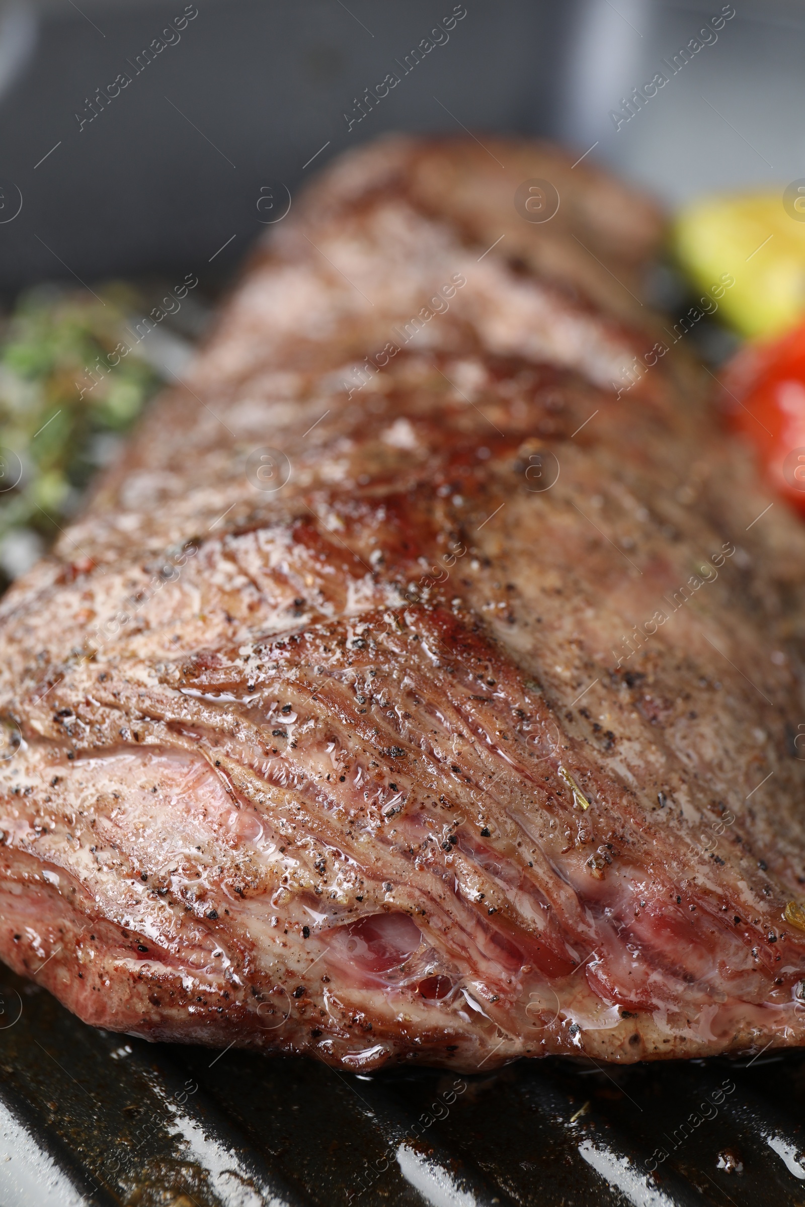 Photo of Delicious grilled beef meat in pan, closeup