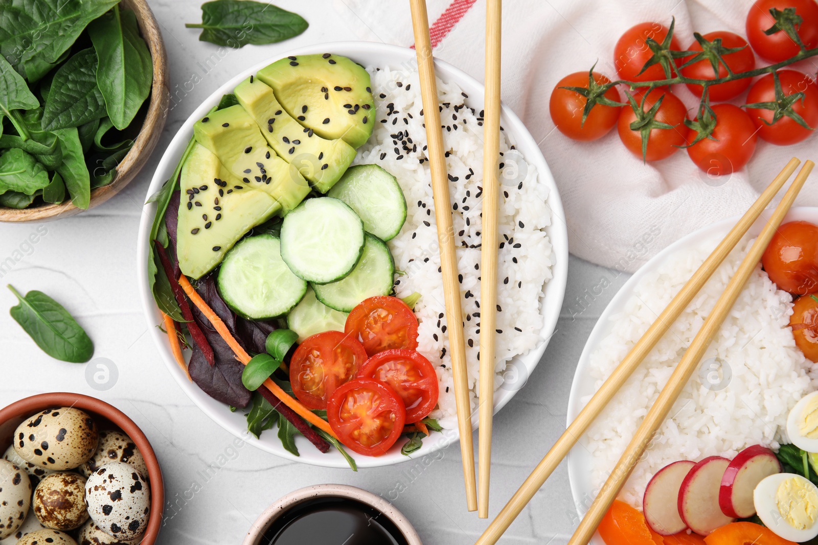 Photo of Delicious poke bowls and ingredients on white table, flat lay