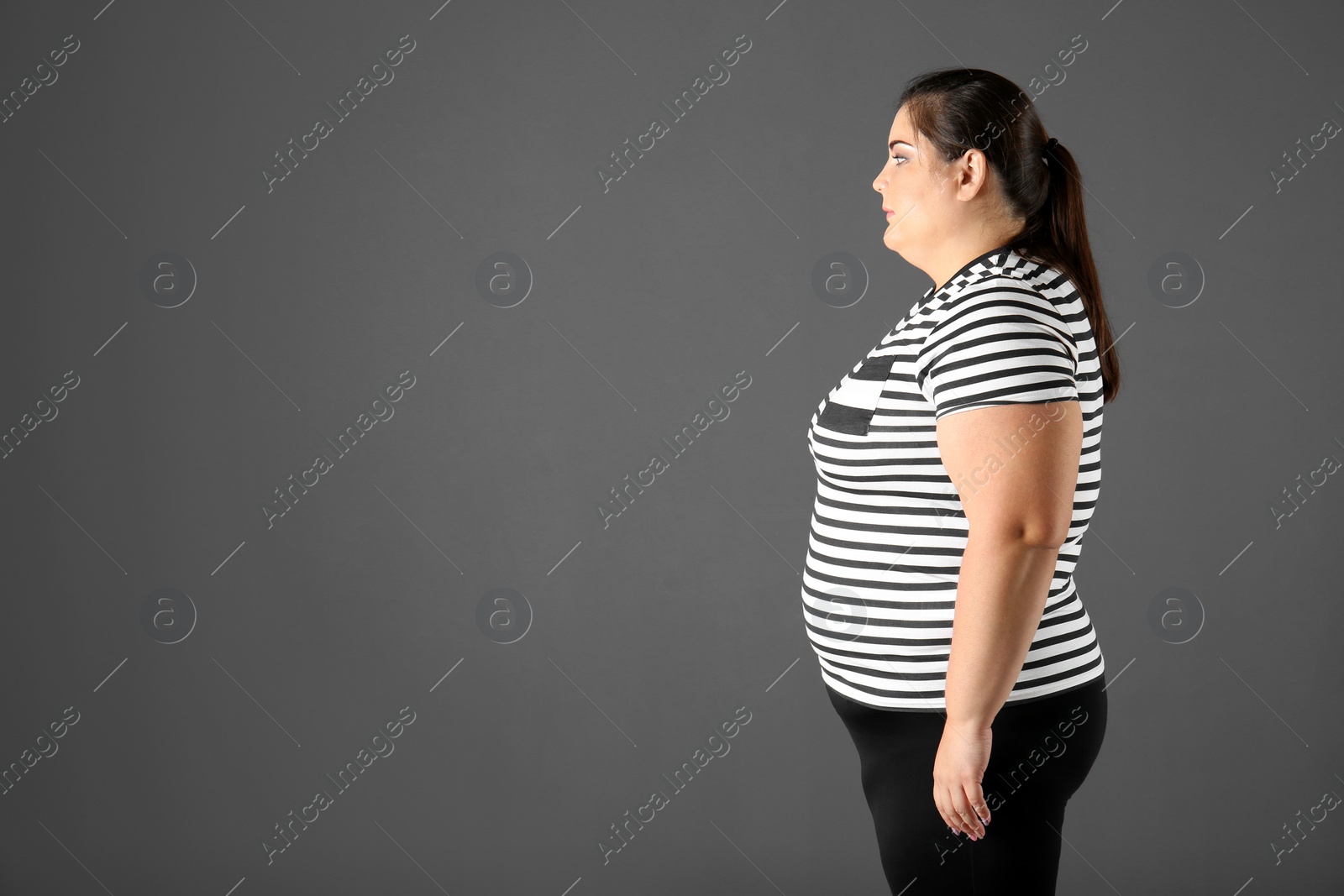 Photo of Portrait of overweight woman and space for text on gray background