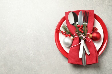 Beautiful Christmas table setting on light grey background, top view. Space for text