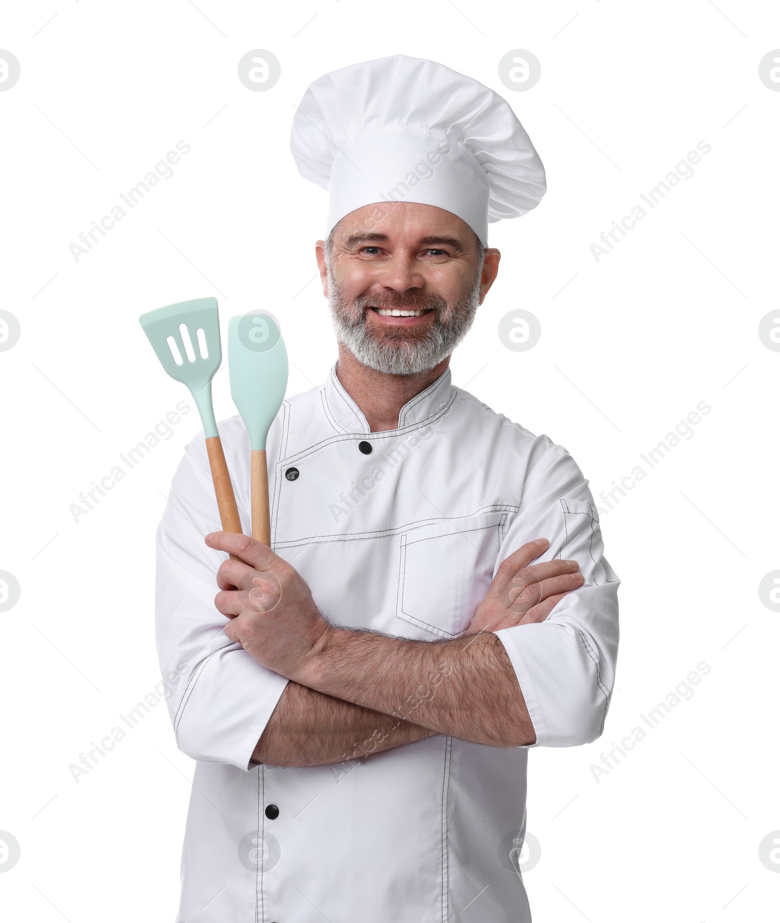 Photo of Happy chef in uniform holding kitchen utensils on white background