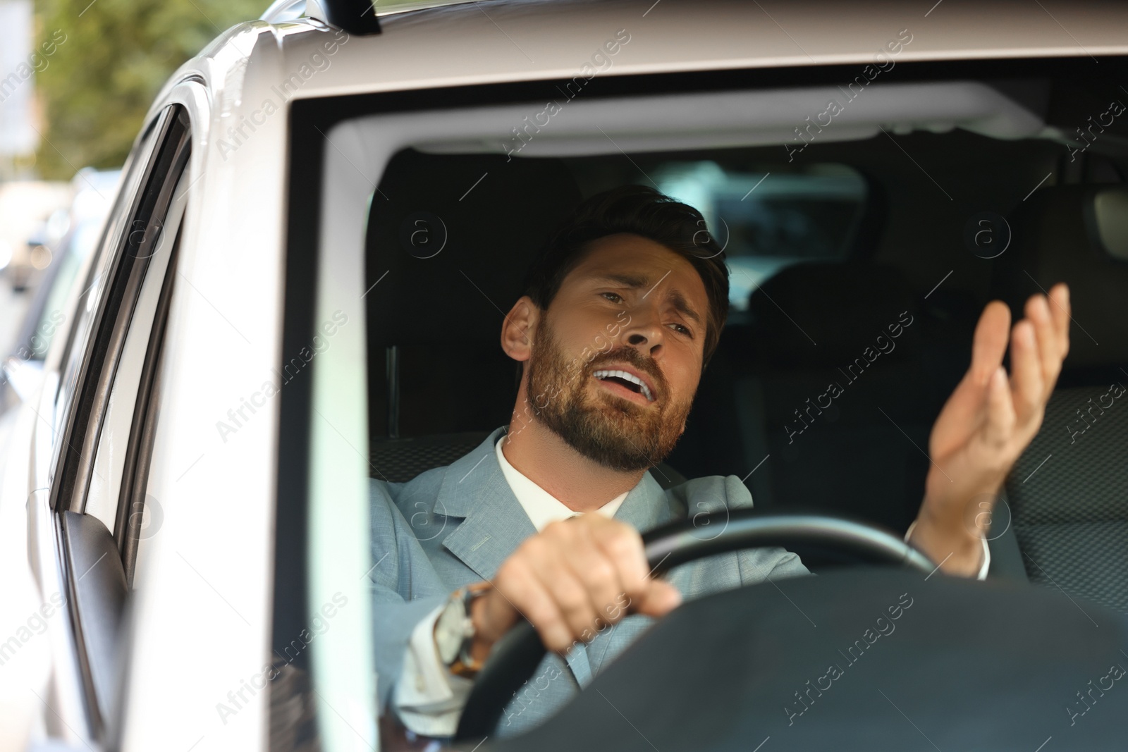 Photo of Stuck in traffic jam. Stressed driver in his car, view through windshield