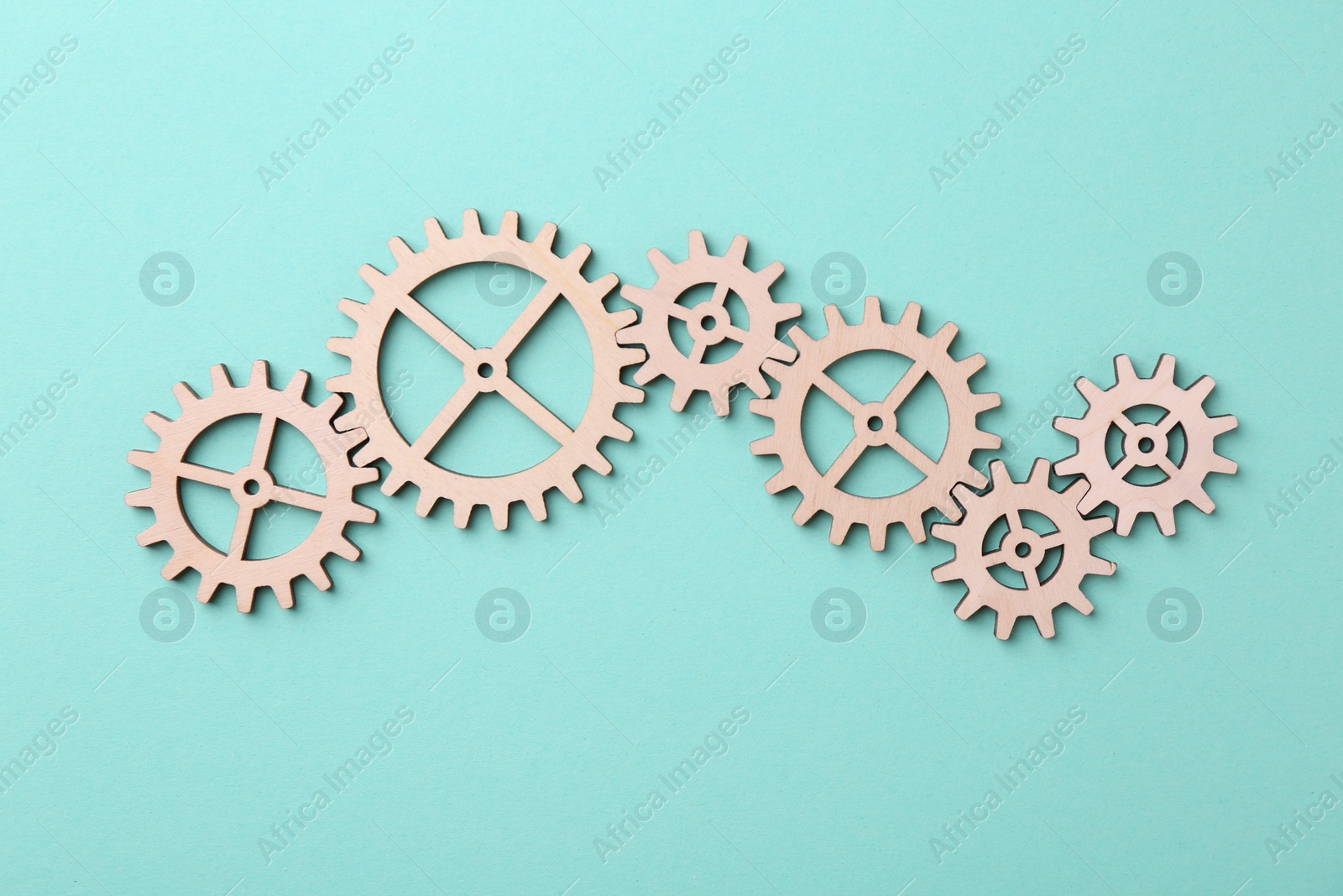 Photo of Business process organization and optimization. Scheme with wooden figures on turquoise background, top view