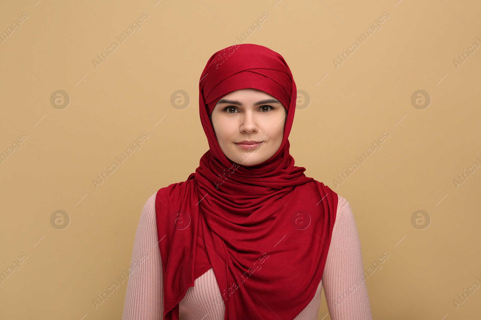 Photo of Portrait of Muslim woman in hijab on beige background