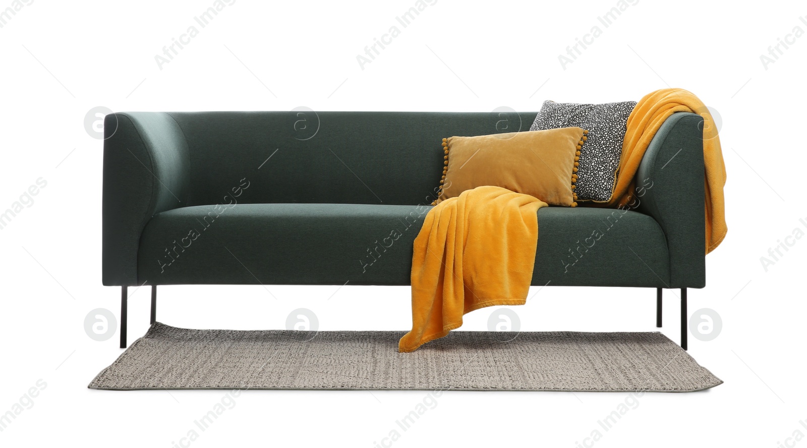 Photo of Comfortable green sofa with cushions, blanket and rug on white background. Furniture for living room interior