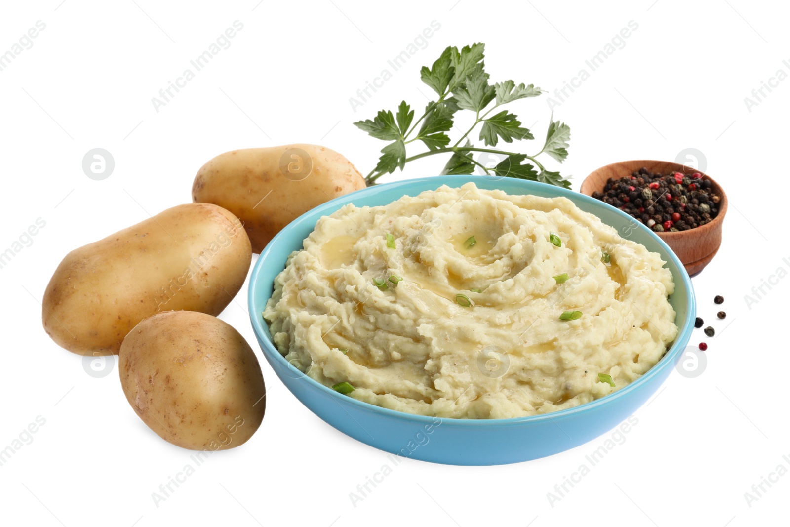 Photo of Bowl of tasty mashed potatoes with ingredients on white background