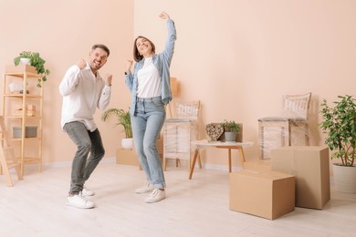 Happy couple having fun in new apartment. Moving day