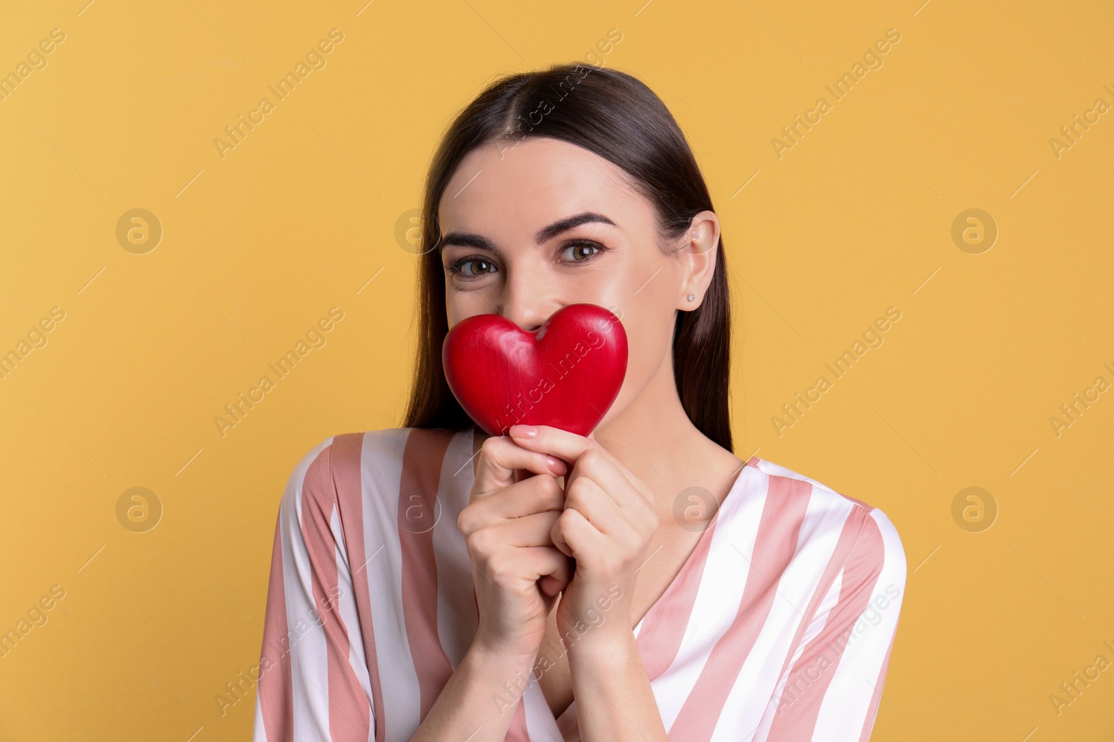 Photo of Portrait of young woman with decorative heart on color background